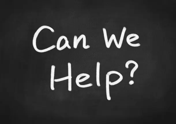 halkboard with the words ‘Can We Help?’ written in white, inviting people to reach out for support with Face2Face Therapy services